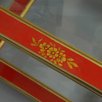 A mid-20th century pair of mallett red lacquer two tier tables