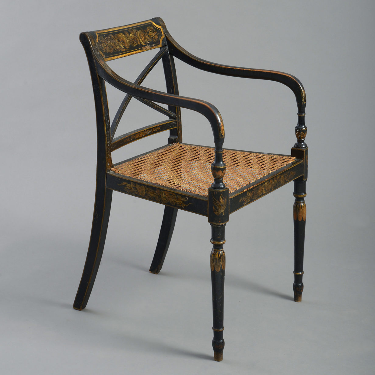 An early 19th century regency period ebonised open armchair