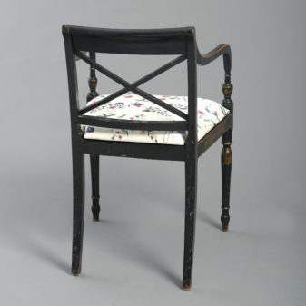An early 19th century regency period ebonised open armchair