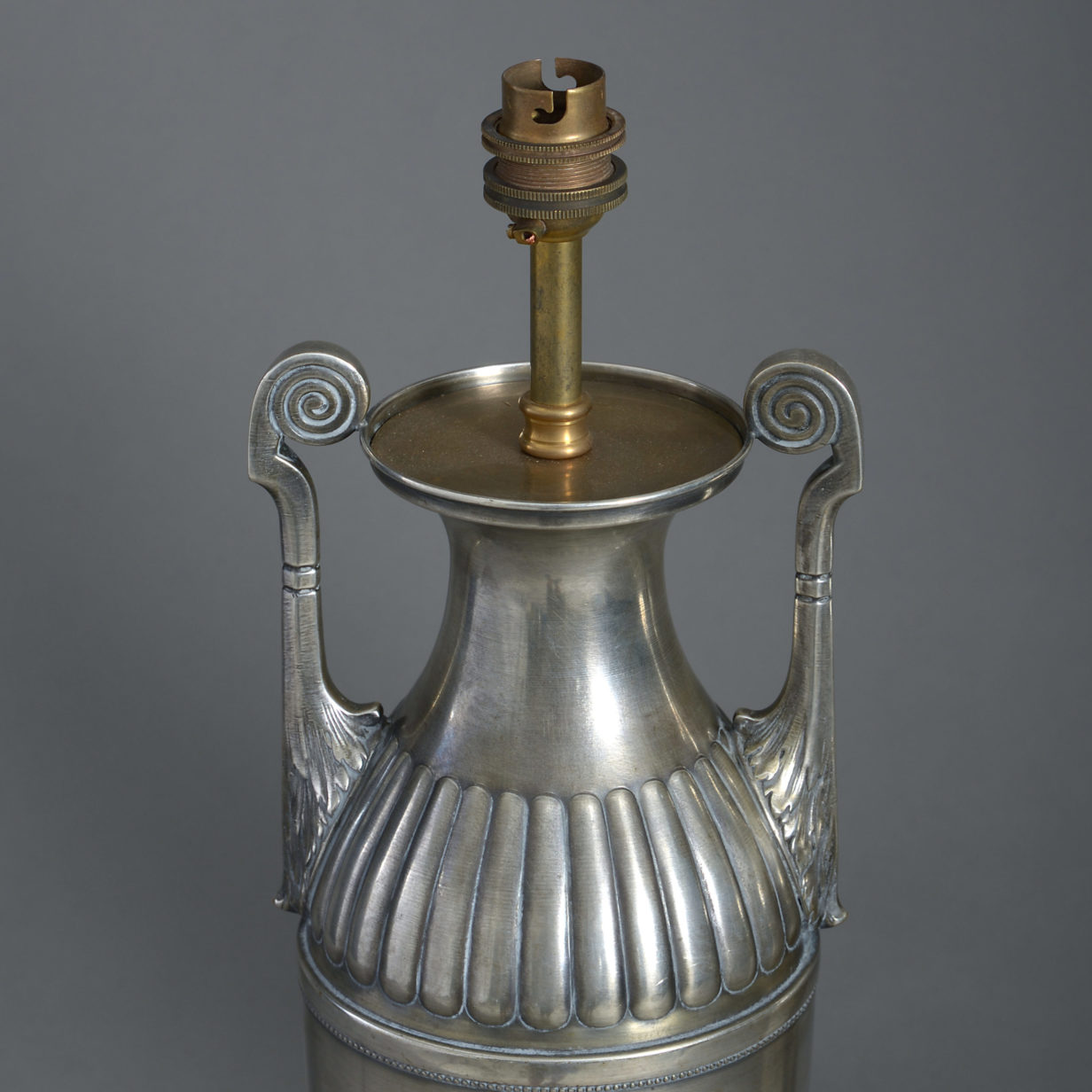 A pair of silvered table lamps