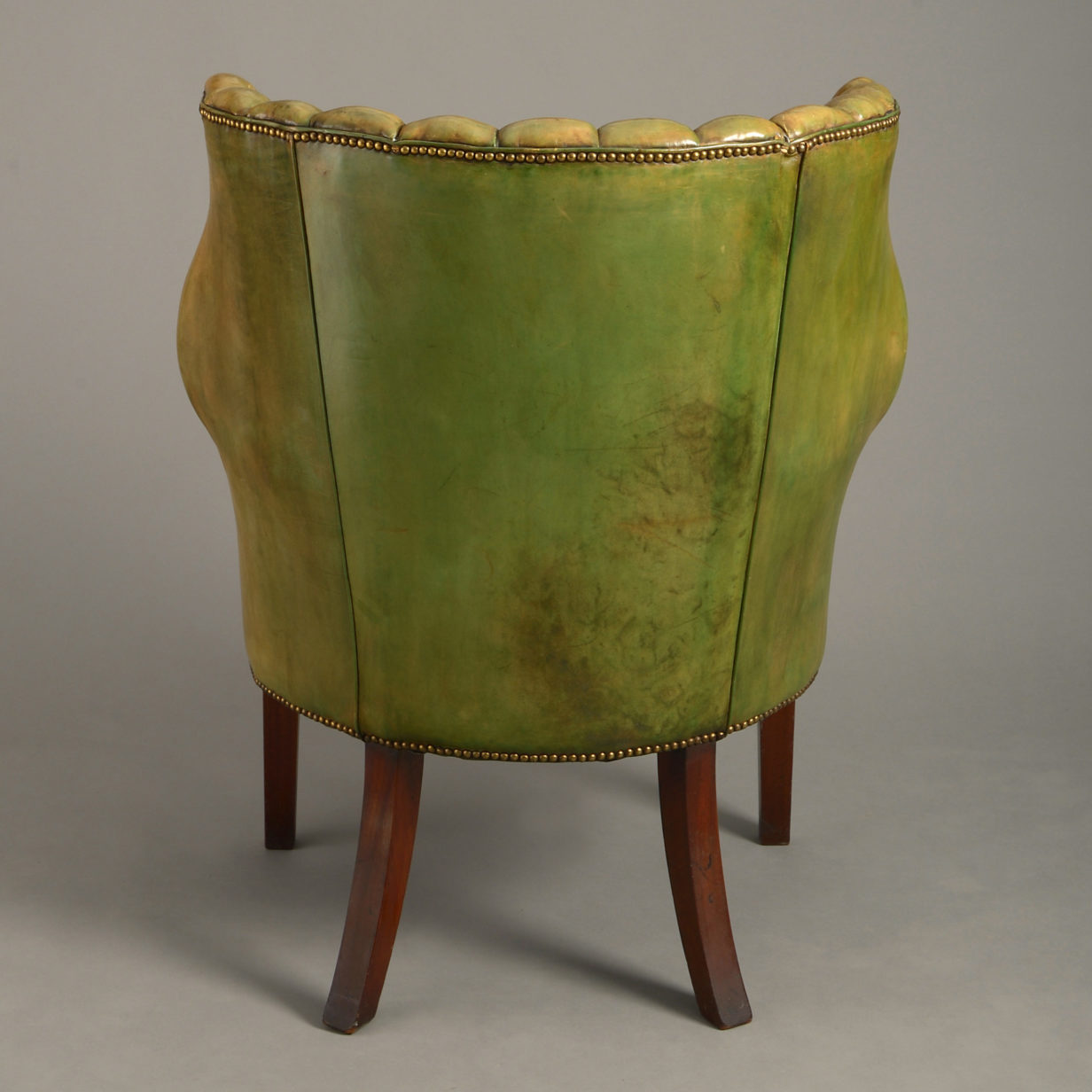 A 19th century george iii style leather upholstered armchair