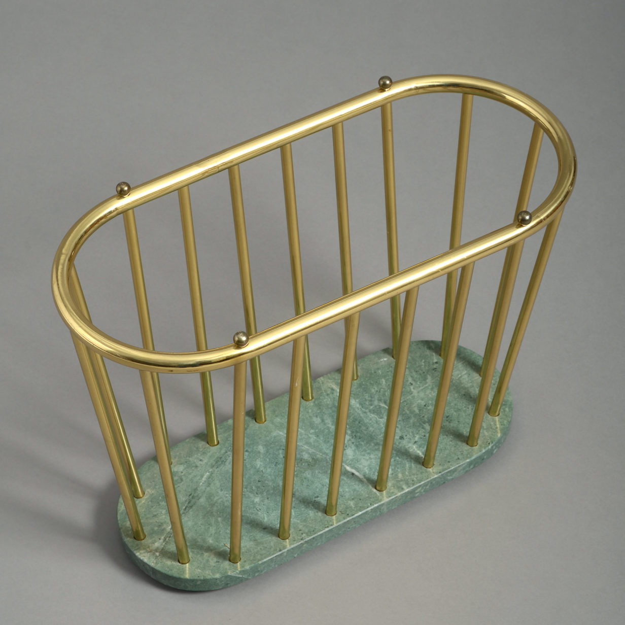 A mid-20th century brass and marble magazine rack