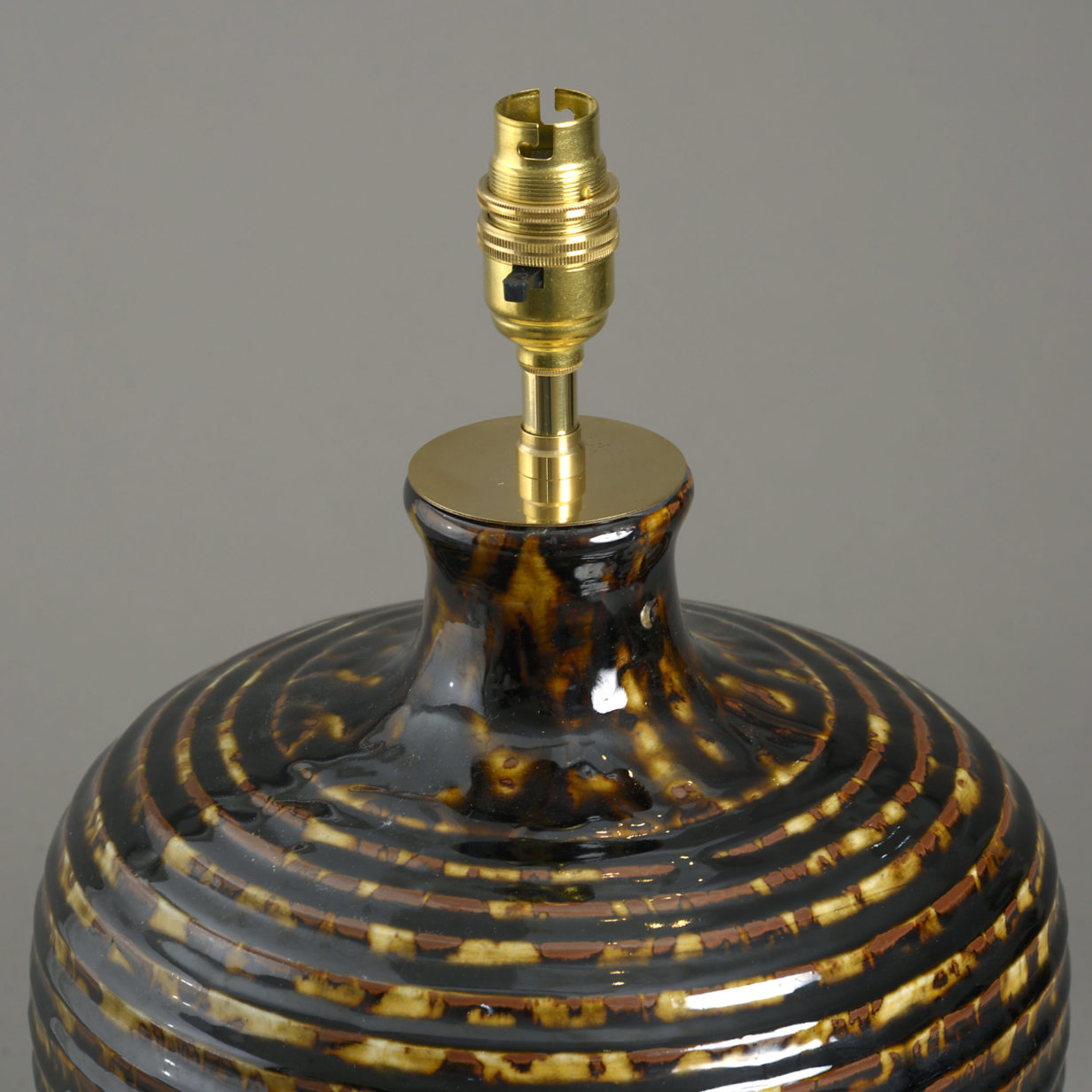 A tortoiseshell glazed ceramic vase lamp