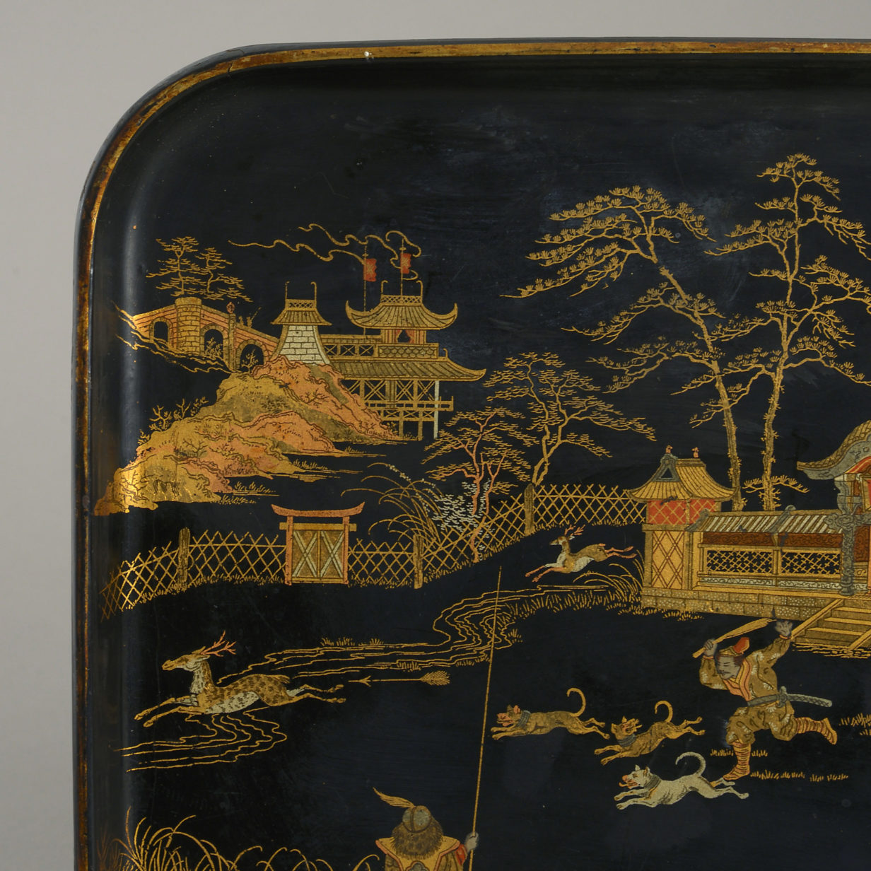 A black and gold lacquer tray