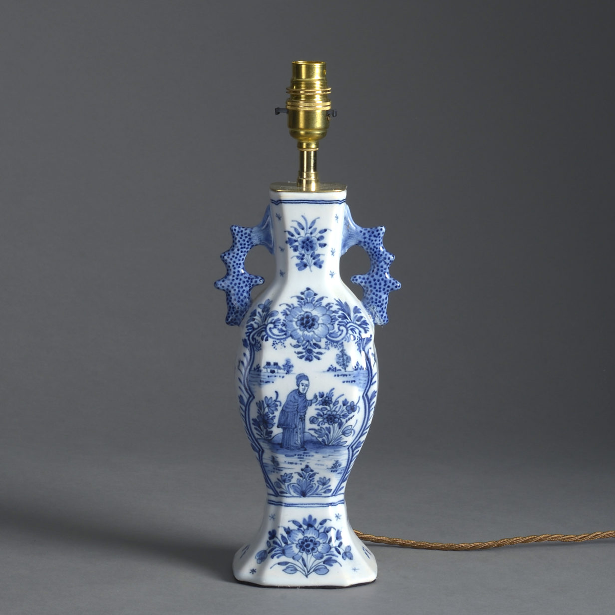 An early 20th century blue and white delft vase lamp