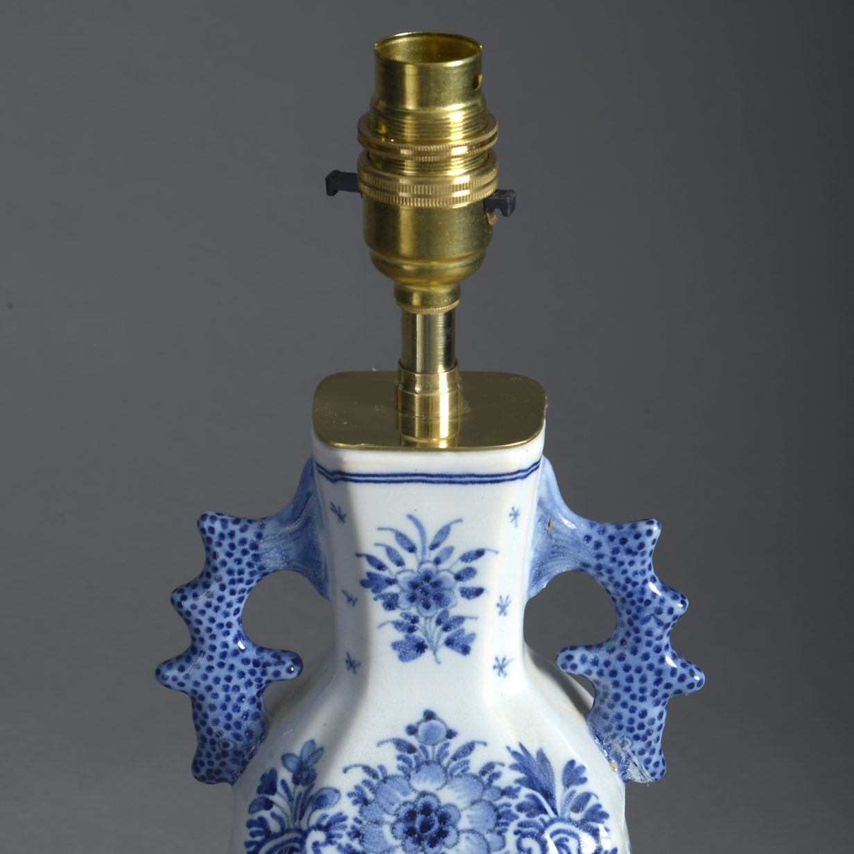 An early 20th century blue and white delft vase lamp