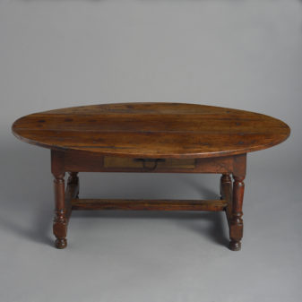 A walnut oval low table or coffee table