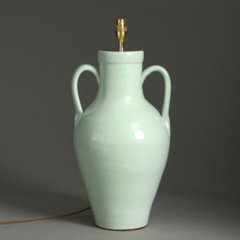 An early 20th century green glazed ceramic vase lamp base