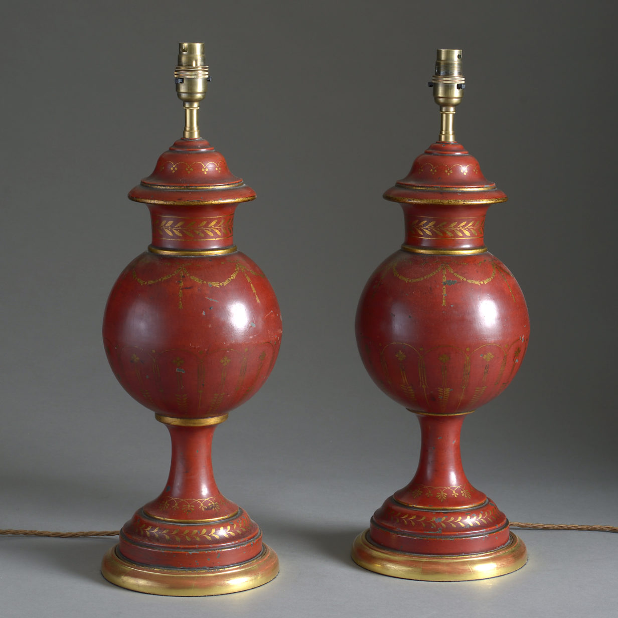 Pair of red & gilded tole vase lamps