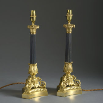 A pair of charles x style bronze & ormolu candlestick lamps