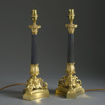 A pair of charles x style bronze & ormolu candlestick lamps