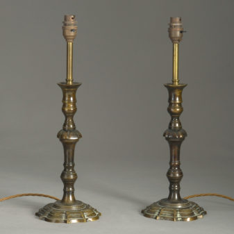A pair of georgian style bronzed candlestick lamps