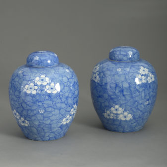 Pair of 19th century blue and white glazed jars and covers