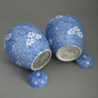 Pair of 19th century blue and white glazed jars and covers