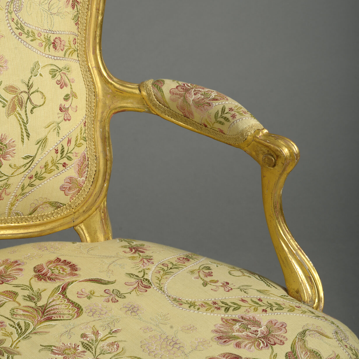A close pair of louis xv giltwood rococo fauteuil armchairs