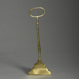 A bell form brass doorstop