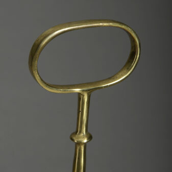 A bell form brass doorstop