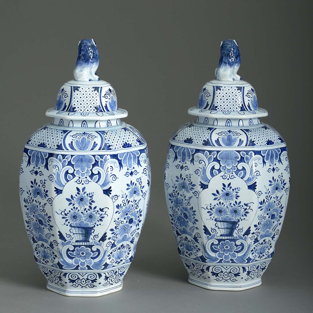 Pair of blue & white glazed delft pottery vases and covers