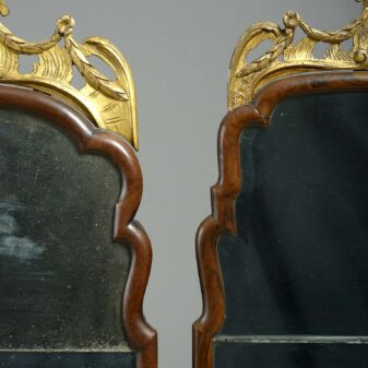 Close pair of walnut and giltwood pier mirrors