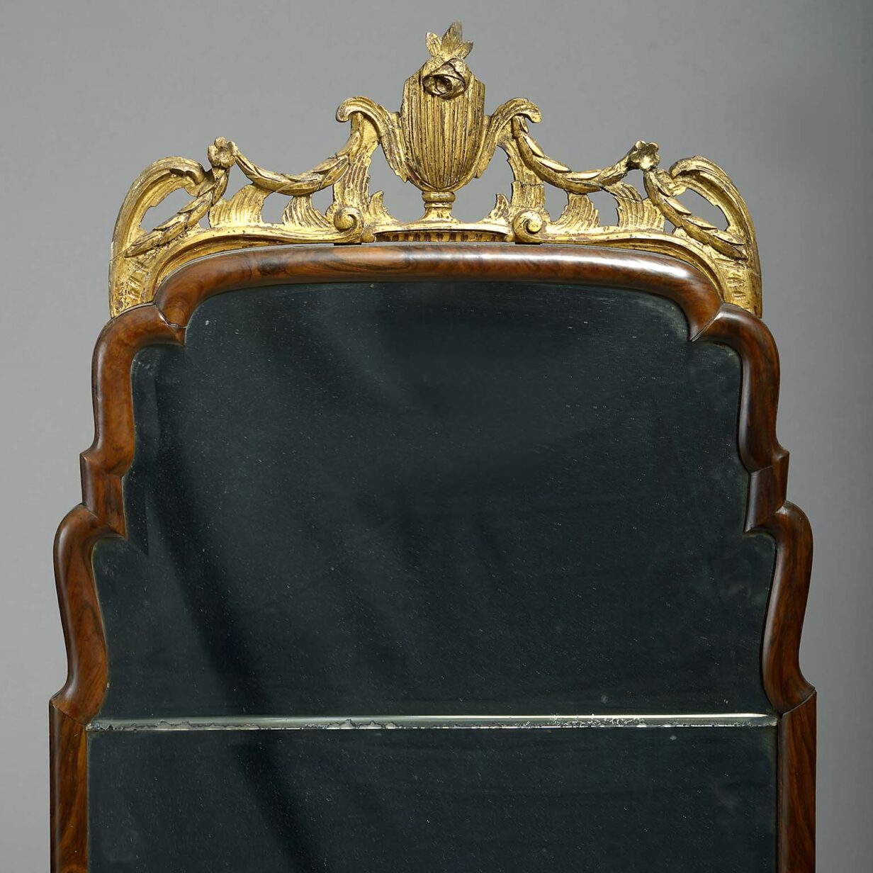 Close pair of walnut and giltwood pier mirrors