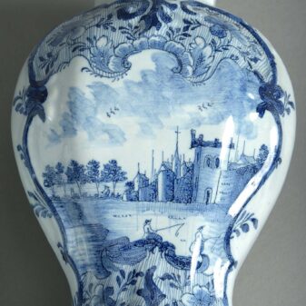 Pair of blue and white glazed delft pottery vases and covers