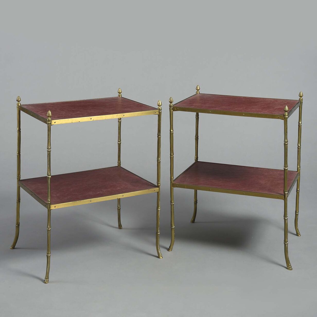 Pair of two tier brass and leathered end tables