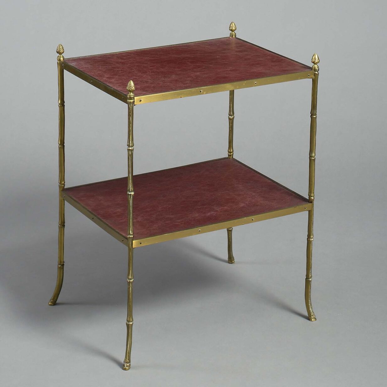 Pair of two tier brass and leathered end tables