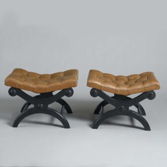 Pair of ebonised x-frame low stools